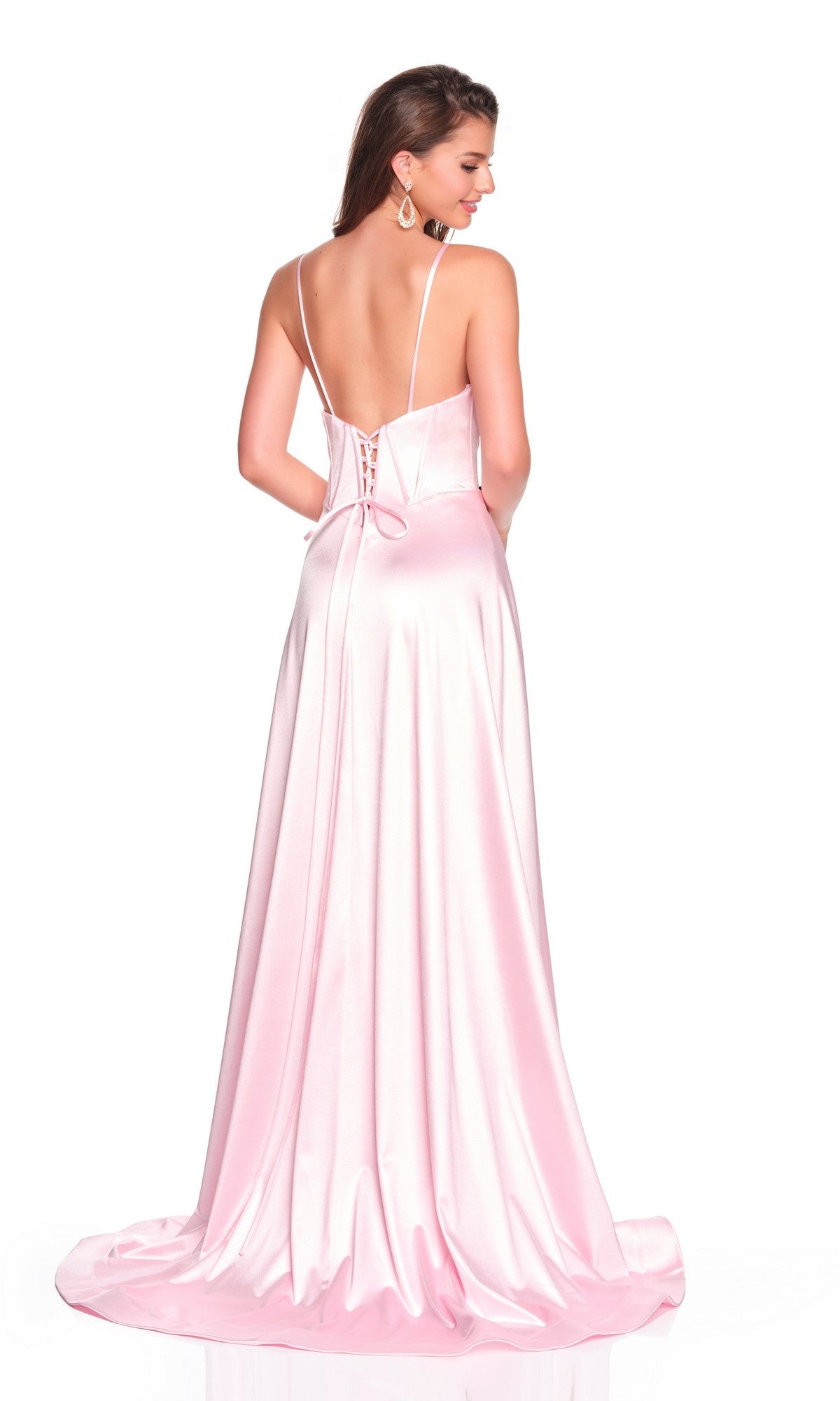A woman models the Dave and Johnny 12534, a long light-pink satin prom dress with spaghetti straps, an open lace-up back, and a flowing A-line silhouette, as she stands looking over her shoulder.